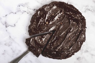 Chocolate cake, round cake, on a marble light table, top view, homemade cakes, no people