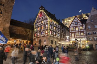 Historic Pilkatushaus with an Advent calendar on 18 December 2024 at dusk, behind the Imperial