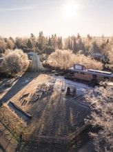 Tipi and caravan in a frosty winter landscape with rays of sunshine, day care centre, Gechingen,