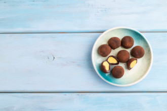 Japanese rice sweet buns chocolate mochi filled with cream on blue wooden background. top view,