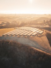 Solar cells on hills in the morning mist under soft sunlight, Magstadt, Germany, Europe