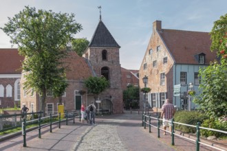 Church tower and old brick buildings, centre of Greetsiel, Krummhörn, East Frisia, Lower Saxony,