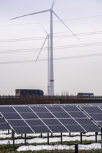 Wind farm in the fog, photovoltaic system, on the A44 motorway, dark doldrums, no wind no direct