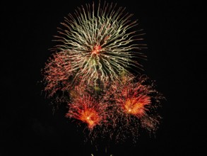 Fireworks in front of black background, orange, white, pyrotechnics, text free space, symbol photo,