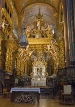 Magnificently designed baroque interior of a church with rich gold decoration and angel figures,