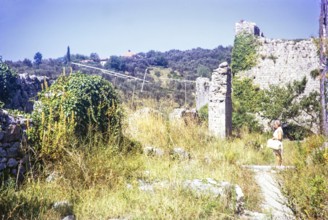 Woman tourist standing in ruins of Old Town, Stari Bar, Montenegro, former Yugoslavia, Europe 1970,