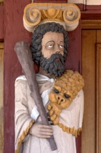 Atlant, figure of the god Hercules, colourfully painted carving on the portal to the town hall,