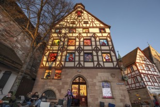 Main facade of the Pilatushaus with 15 windows of the Advent calendar created by the Alstadtfreunde