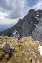 Mountaineer with helmet on a hiking trail, descent from the Maukspitze, rocky mountain peaks with