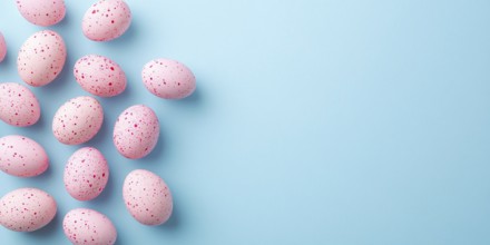 Pastel pink Easter eggs with dots on side of blue background with copy space. Generative AI, AI