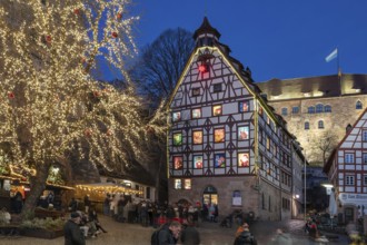 Historic Pilatus House with an Advent calendar designed by the Altstadtfreuden Nuremberg, behind