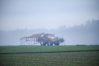 Farmer with tractor fertilising, Rottenschwil, Canton Aargau, Switzerland, Europe