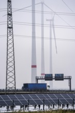 Wind farm in the fog, photovoltaic system, on the A44 motorway, dark doldrums, no wind no direct