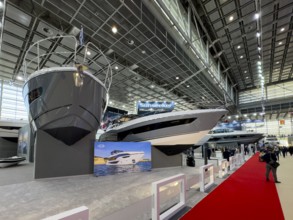 View of bow of Sunseeker luxury yachts superyachts ships boats in exhibition hall of public fair