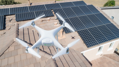 UAV drone inspecting solar panels on large house