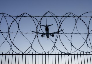 Symbolic image security at the airport, outer fence at Düsseldorf International Airport, steel wire