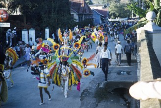 People in colourful costumes at the carnival parade, Port of Spain, Trinidad 1963 with the title