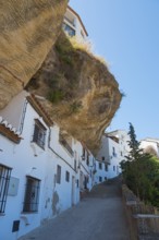 Street in Setenil de las Bodegas with overhanging rock, sunny, cave dwellings, Setenil de las