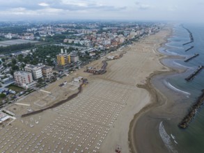 Bathing beach in Rimini. Bathing beach on the Adriatic in bad weather. All deckchairs are free.