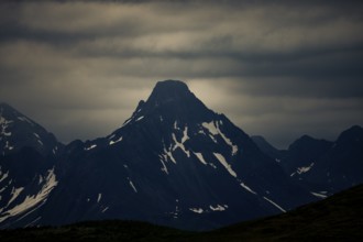 Summit of the Biberkopf in the morning light with dramatic clouds, Lech, Lechquellengebirge,