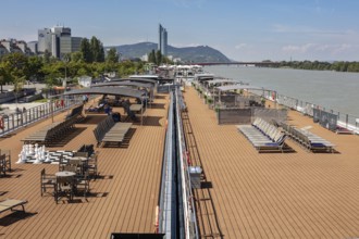 Lounge deck on the riverbank with a view of the city, Vienna