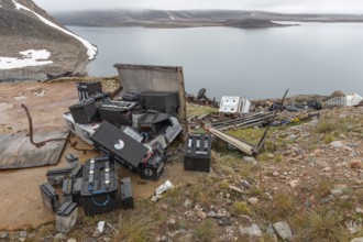 Various discarded batteries and scrap metal, Arctic settlement Ittoqqortoormiit, Scoresbysund or