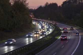 Lights from cars illuminate the motorway at dusk as traffic flows, Rems-Murr district,