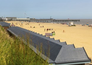 View over roofs of beach huts to Claremont Pier, South Beach, Lowestoft, Suffolk, England, UK