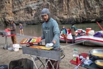 Dinosaur, Colorado, River guide Sam Crittenden cooks breakfast for river rafters on the Green River