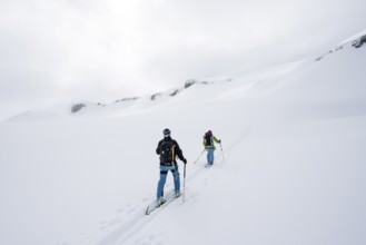 Ski tourer in the fog on the glacier Glacier de la Plaine Morte, mountain landscape with snow,