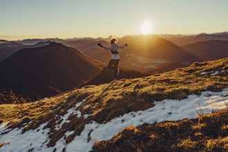 Trail running in autumn on the Jochberg on Lake Walchensee against the wonderful backdrop of the