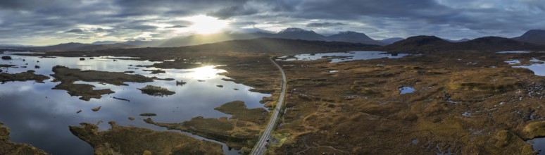 Morning light, cloudy mood, sunbeams, loch, moor, mountain landscape, aerial view, panorama, road,