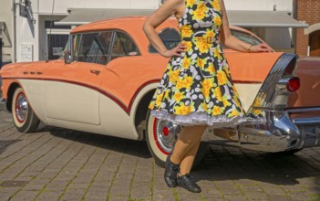 Vintage American road cruiser Buick with woman and petticoat