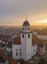 Romantic view of a bell tower at dusk over the cityscape, Meßkirch, Sigmaringen district, Germany,