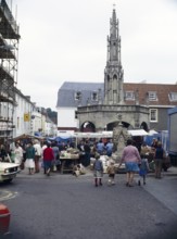 People shopping at the street market, Market Place, Shepton Mallet, Somerset, England, UK 1970s