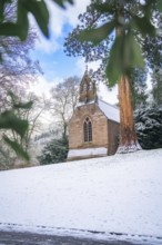 Small church in the snow, surrounded by wintry trees and a clear sky, spa garden, English Church,