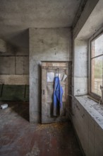 Milk room with rubber apron in the abandoned cowshed of a former GDR agricultural co-operative,