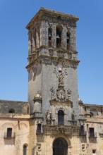 Historic bell tower with intricate sculptures, a clock and detailed stonework, Basilica Santa María