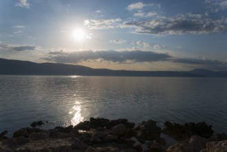 Sunny sky over a calm sea with reflecting sunlight, Glavotok, island of Krk, Primorje-Gorski kotar,