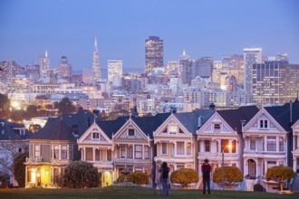 The Painted Ladies, Victorian wooden houses on Alamo Square and the San Francisco skyline at dusk,