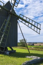 Three traditional historic windmills (Resmo väderkvarnar) in the village of Resmo on Öland, Kalmar