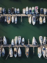 Marina with yachts aerial drone top down view. Boats and yachts moored by the pier. Cascais,