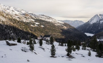 Zufallhütte mountain hut, view of the Martell Valley, snow-covered mountain landscape in winter,