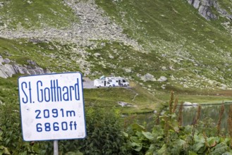 Gotthard Pass. Pass summit with sign and caravan park. Airolo, Canton Ticino, Switzerland, Europe