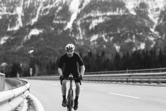 Road bike rider in spring between Lechtal and Tannheimer Tal in front of picturesque scenery of the