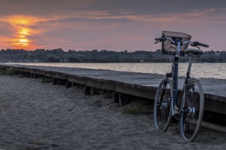 Bicycle at the jetty with orange sunset at the sea, calm evening mood, Nin, Zadar, Croatia, Europe