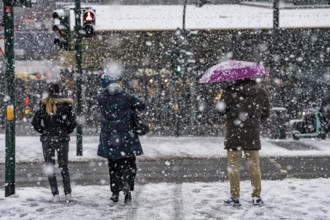 Winter weather, heavy snowfall, city centre traffic, passers-by in the snow, North