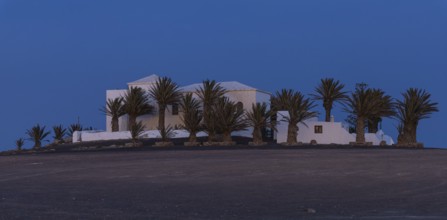 Church surrounded by palm trees at dusk, Canary Islands, Lanzarote, Spain, Europe