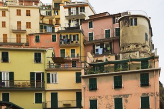 Colourful pink, yellow, and olive green stucco cladded multi story residential apartment buildings