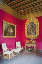 Baroque room with elaborate portraits and gold-framed paintings on red walls, Louis XIV Salon,